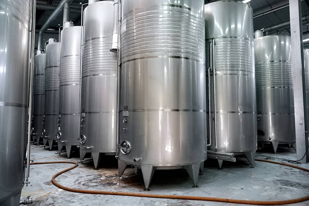 Stainless steel wine barrels at sustainable winery using Sublime Environmental water treatment system for organic production processes