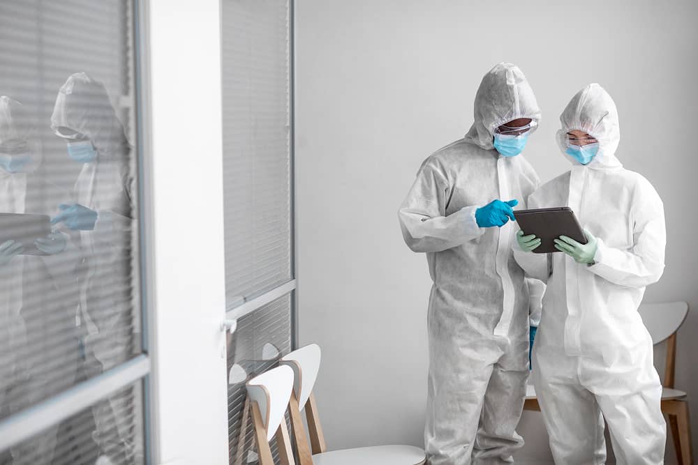 Pharmaceutical workers in protective equipment using Sublime Environmental ozone water treatment in biohazard area for ultra-pure water production